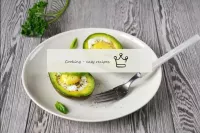 Transfer the hot avocado with the egg to a dish, s...