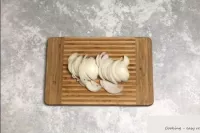 Peel the onions and cut into half rings. ...