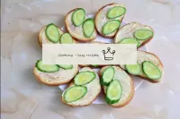 Place the chopped cucumbers on the slices of the l...