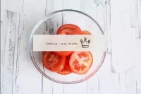 Wash the tomatoes, dry and cut into circles or wed...