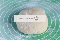 Gradually adding sifted flour, knead the dough wit...