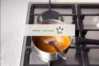 Cook the caramel over a low heat while stirring co...