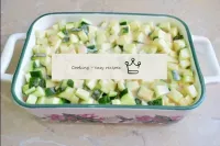 Water the courgettes evenly. Cover the tin with fo...