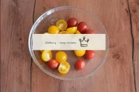 Wash the cherry tomatoes, dry and cut in half. If ...