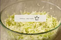 Mash the cabbage with your hands with sugar and sa...