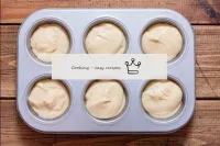 Pour dough into the selected muffin moulds, fillin...