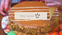 We decorate the side of the cake with crumbs and m...