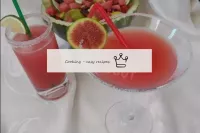 Garnish the cocktail with slices of fruit and spri...