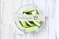 Rinse the cucumbers, dry and cut into thin, long s...