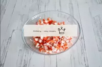 Clean the crab sticks from the film and cut into s...