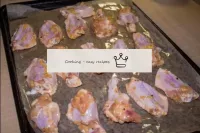 Transfer the wings to a baking sheet greased with ...