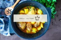 Braised chicken with potatoes in kazan on the stov...