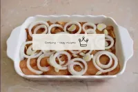 Peel and cut the onions into circles. Spread the c...