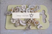 Rinse fresh champignons in running water to wash a...