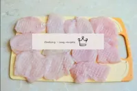 Cut the chicken breasts into small pieces and beat...