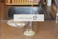 Pour condensed milk into a glass. ...