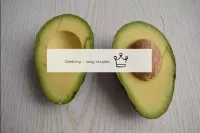 Cut the avocado along in a circle and turn the hal...