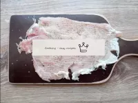 Cover a piece of pork with thick film and beat wel...