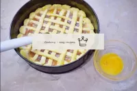 Use a brush to brush the top of the pie with egg y...