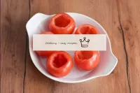 Wash the tomatoes, dry. Cut off the tops and caref...