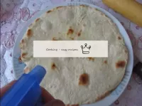 We remove the finished pita bread and spray it wit...