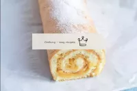 Cut the finished apple sponge roll on both sides a...