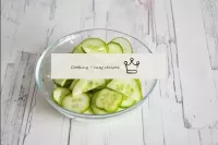 Wash the cucumber, dry and cut into half rings. ...