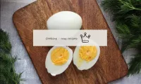 Clean the cooled eggs from the shell and cut arbit...