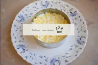 Place the grated eggs in the next layer. Grease th...