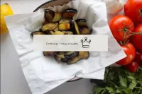 Put the ready-made eggplants on paper napkins to g...