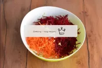 In a bowl, combine the cabbage, beetroot and carro...