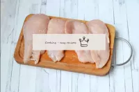 Wash the chicken fillet, dry and cut in half along...