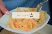 Put the cooked pickled cabbage with carrots and ga...