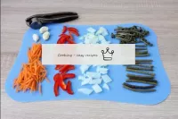 Start cooking by slicing the vegetables, which you...