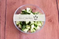 Wash the cucumber, dry and cut into quarters. If t...