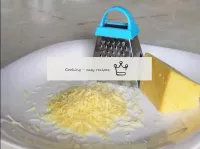 We rub the cheese on a fine grater. ...