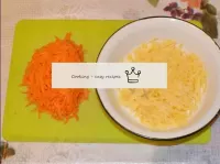 Grate cheese and carrots on coarse grater in diffe...