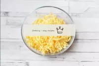 Grate the cheese on a medium grater. Cheese will s...