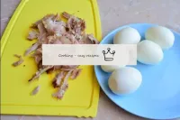 Peel the boiled eggs from the shell. Separate the ...