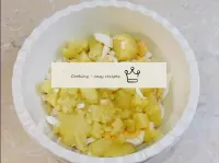 Peel the potatoes and dice them. Add the chopped p...