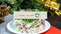 Olivier salad with vegetables and beef under the s...