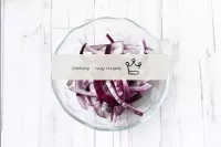 Peel the red onion and cut into thin half rings. O...