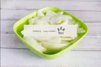 Peel and cut the onions into thin half rings. Tran...