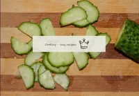 Cut fresh cucumber into thin halves of lobes. Alth...