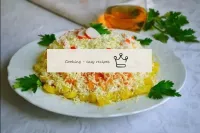 Garnish the salad with slices of crab sticks and p...