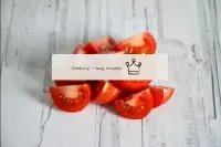 Cut the cherry tomatoes into quarters. Tomatoes ca...