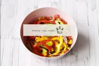 In a bowl, combine bell peppers, red onions and he...