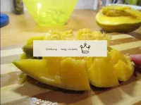 We cut the mango in half. Cut directly into the pe...