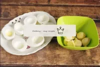 Peel the boiled eggs, cut lengthways into 2 parts,...