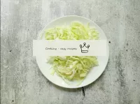 Cut the young fresh cabbage very thinly, you can u...